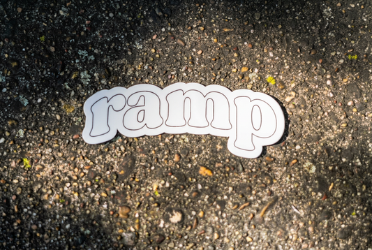 Straightened and centered ramp sticker photo with brighter exposure, sharper detail, and the natural pavement background preserved